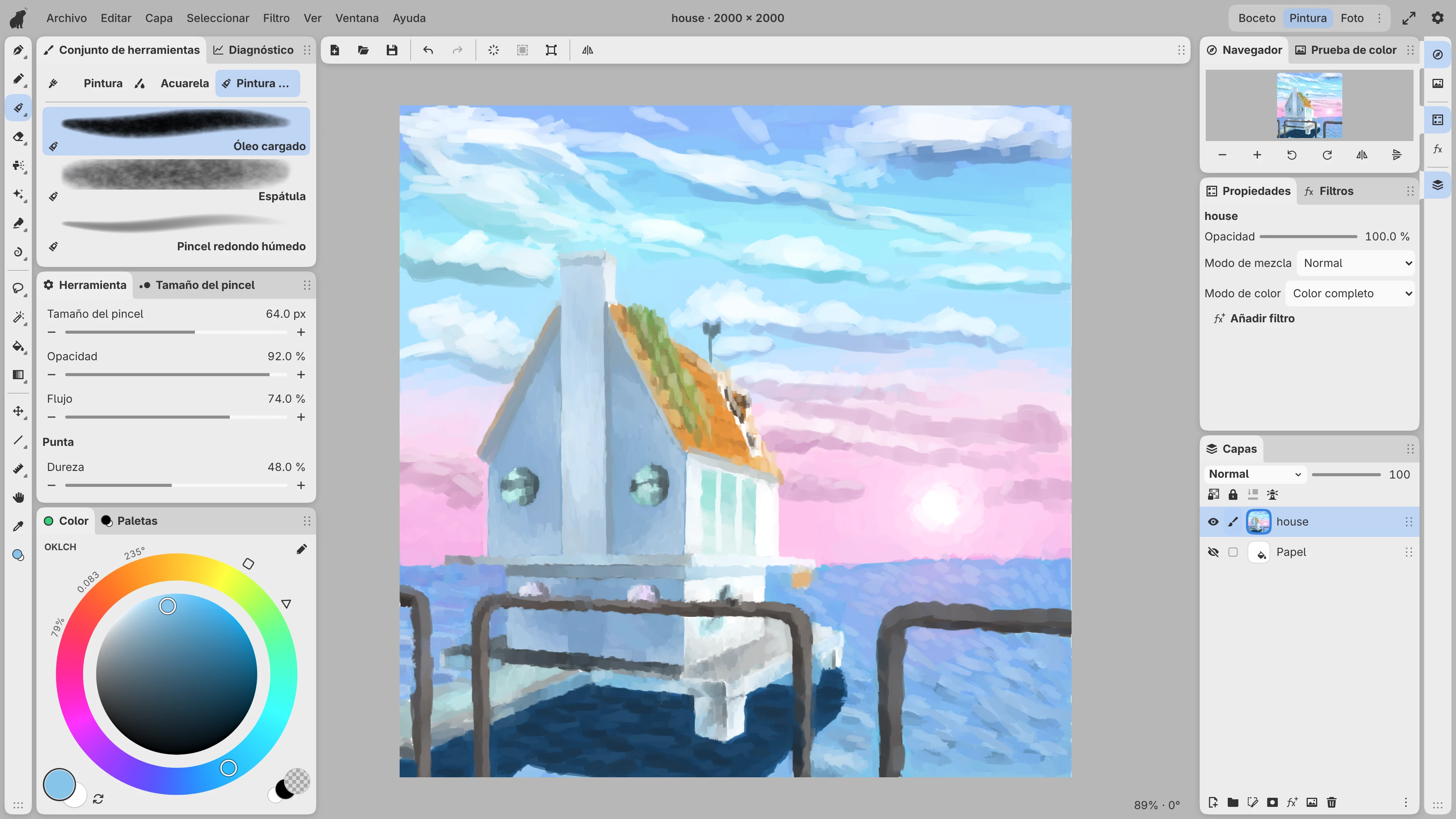 Una pintura al óleo de una casa junto al mar al atardecer en el espacio de trabajo Paint, con pinceles, colores y capas al lado del lienzo.